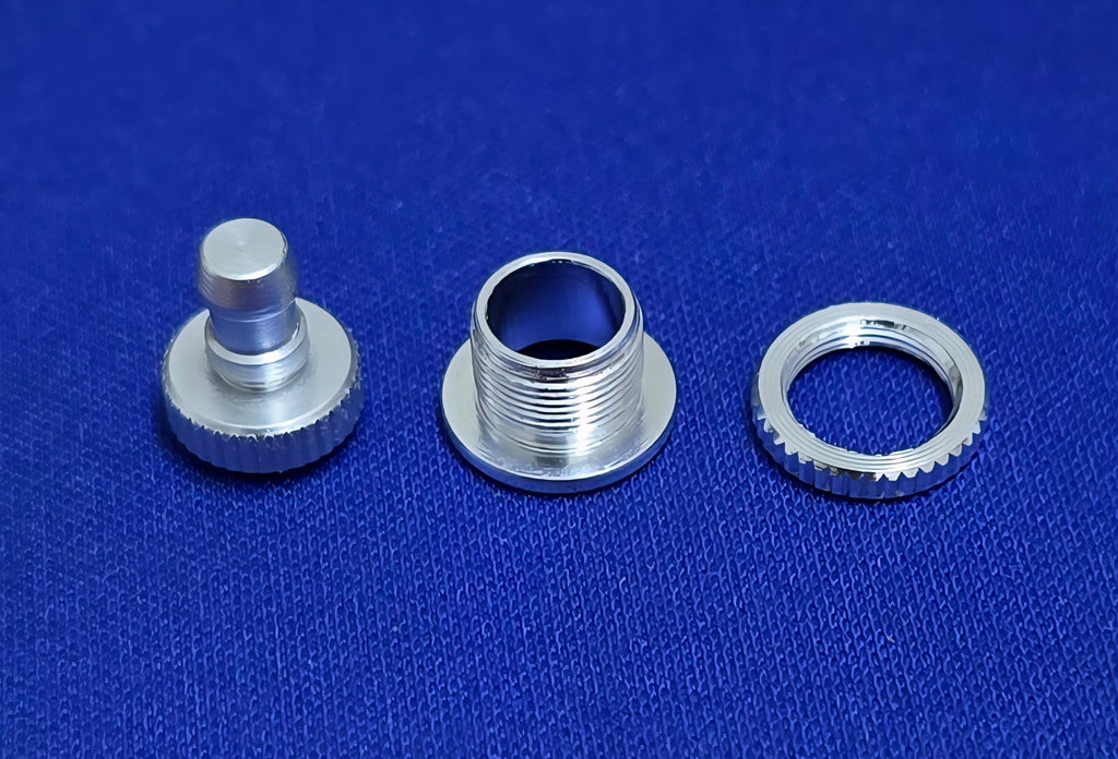 Three metallic components of Fuel Dot AeroNautical on a blue textured background.