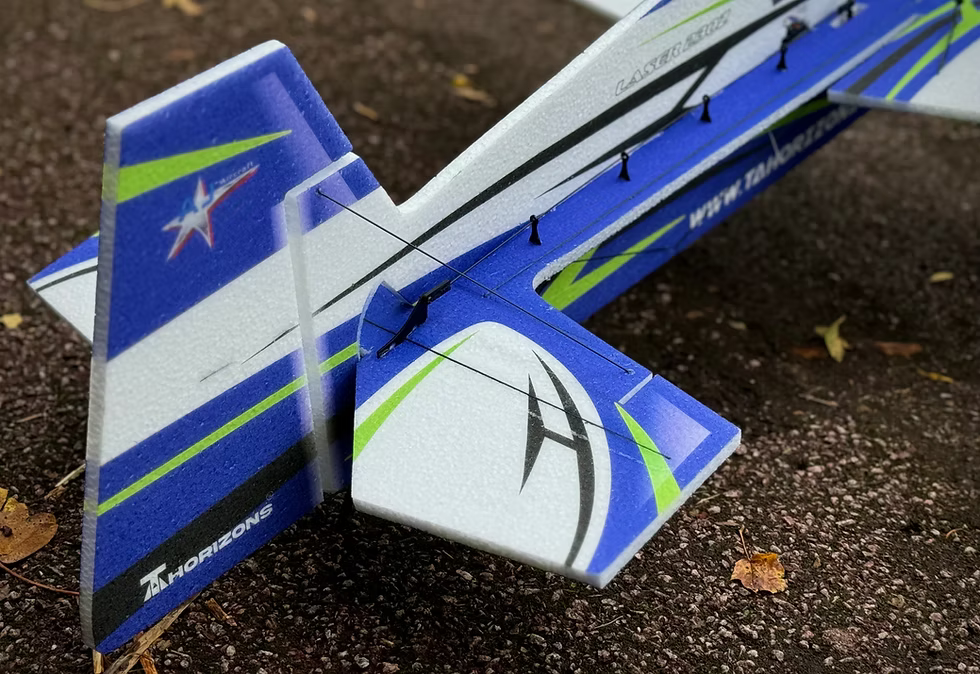 Model airplane on a dark surface with 'HorizonHobby' branding.