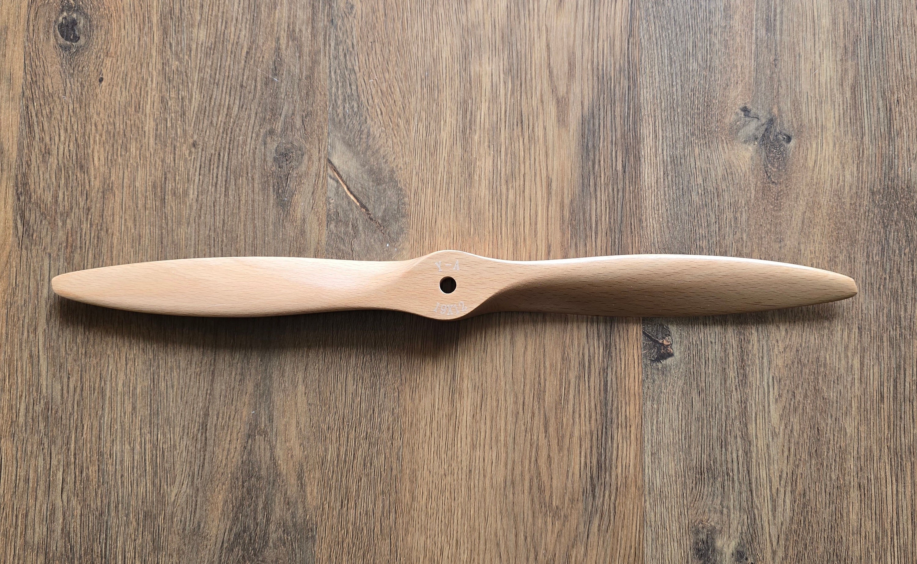 Wooden propeller 19x12 on a wooden surface