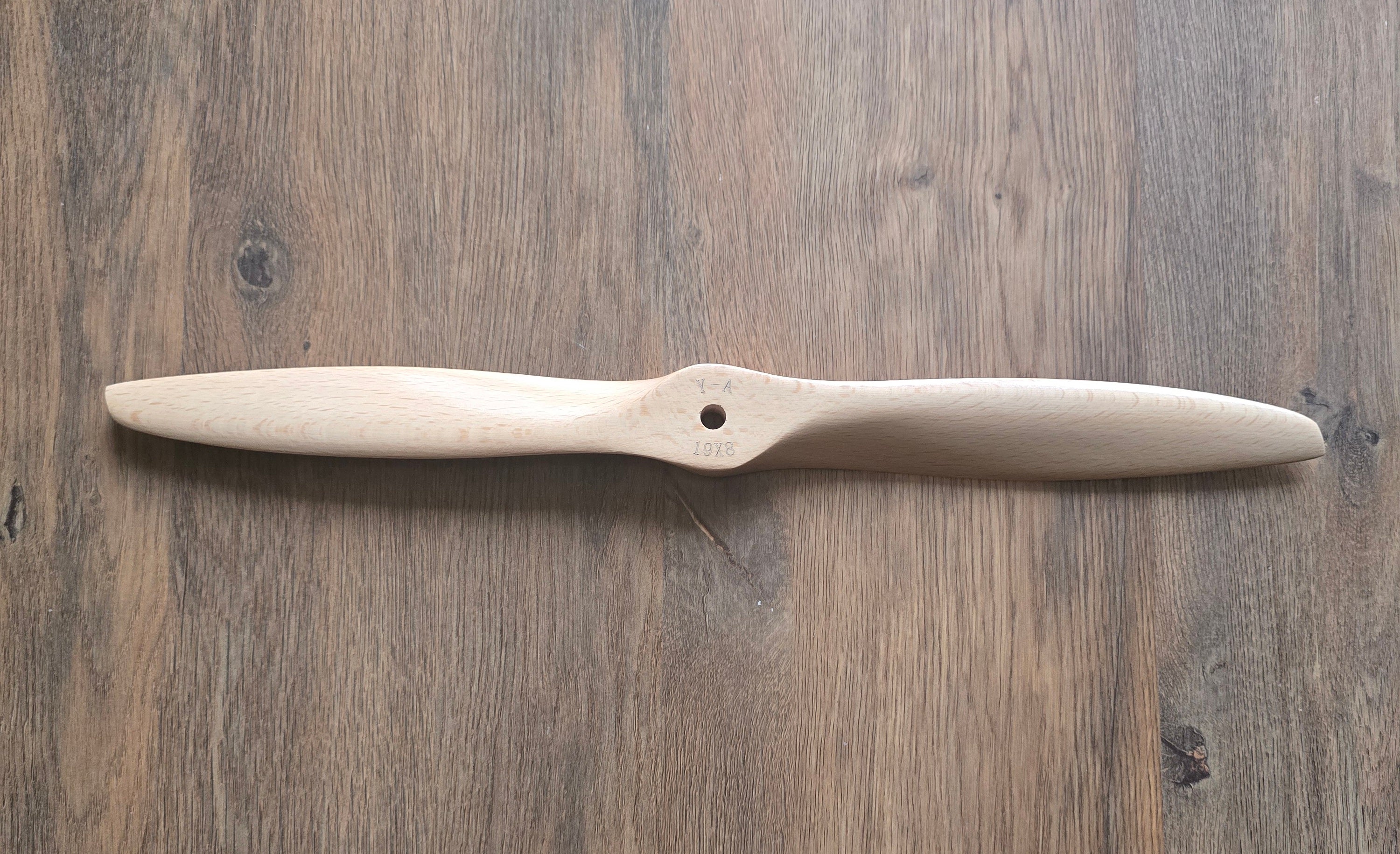 Wooden propeller 19x8 on a wooden surface