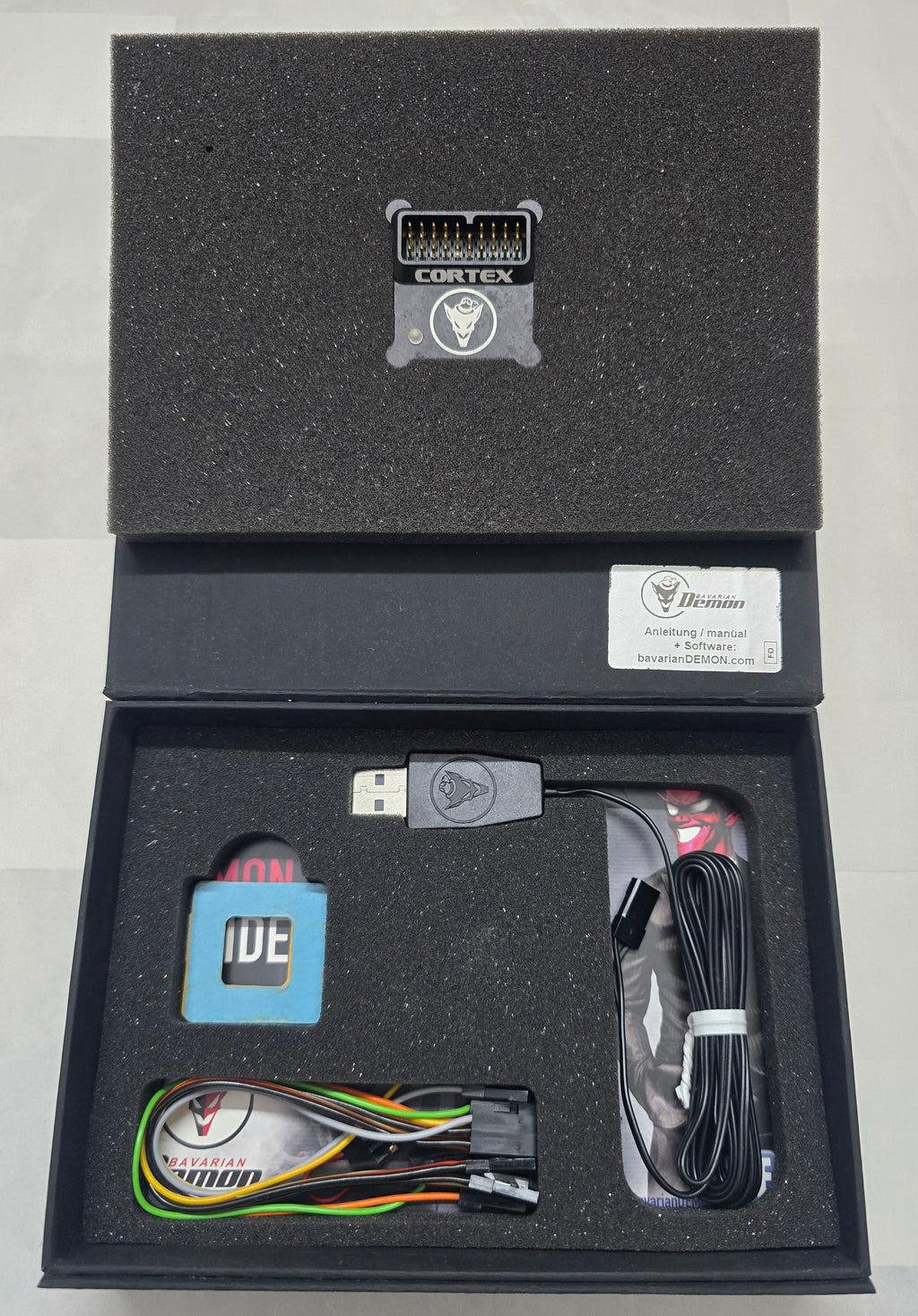 Electronic components in a black box with visible branding