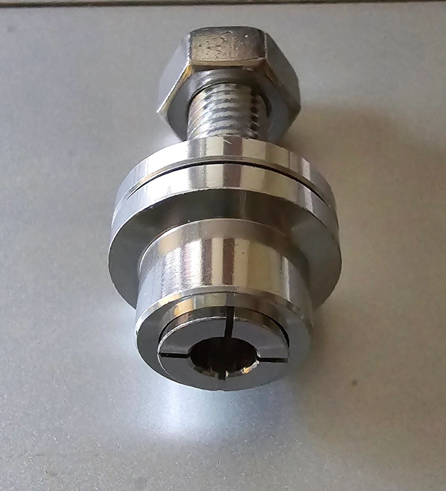 Metal tool or component on a gray background