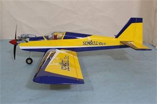 Model airplane with yellow and blue design on a gray surface