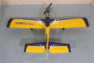 Model airplane with 'Sea gull 10cc' branding on a gray surface